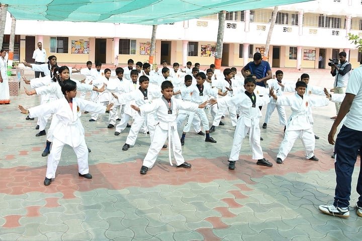 Students doing a karate drill in the school quadrangle